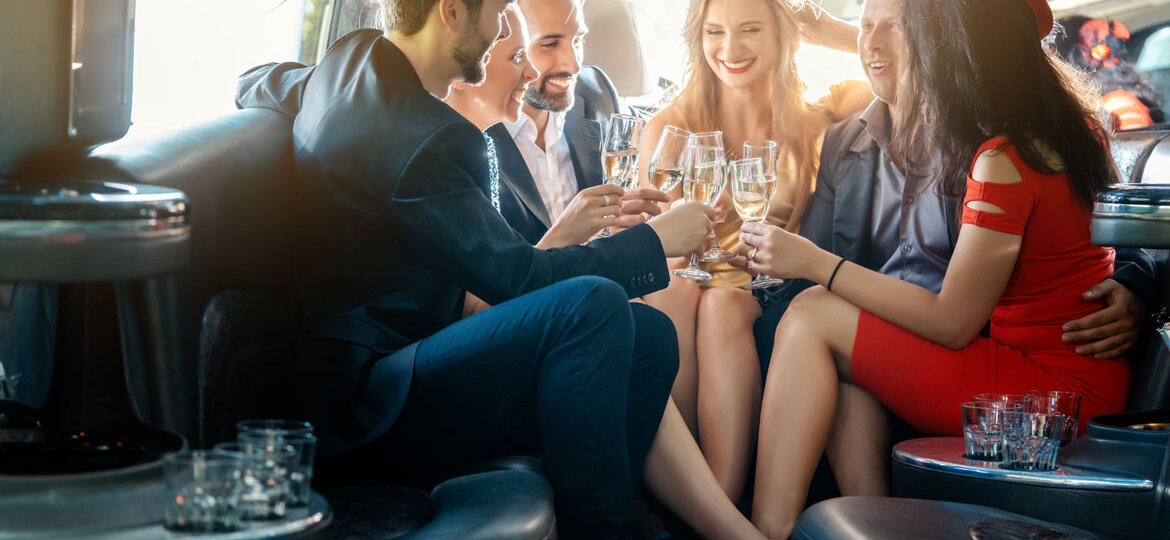A group of people toasting champagne in a party bus