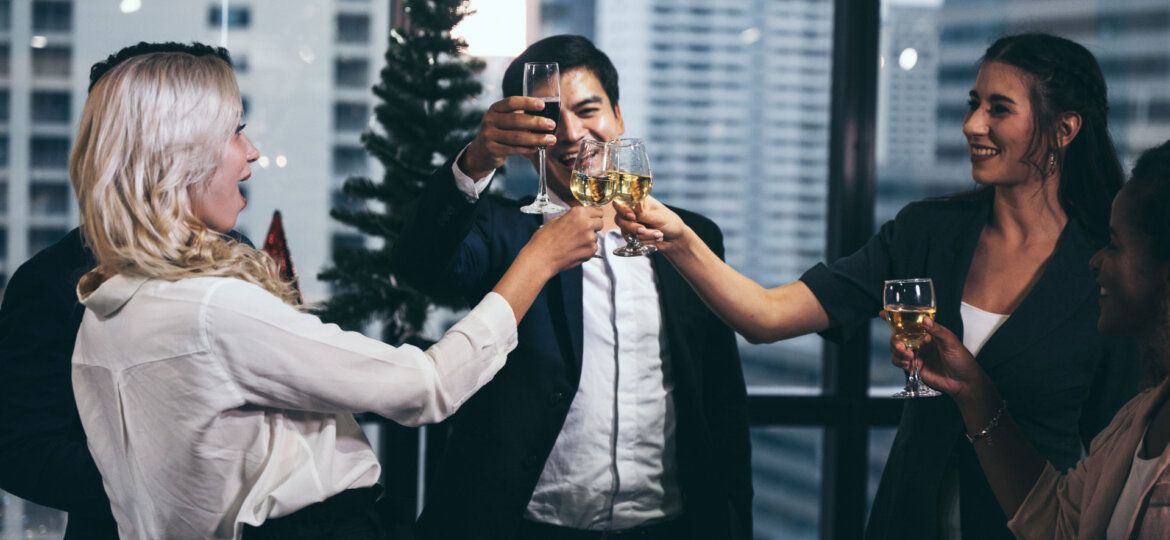 Employees cheering after getting a limousine rental to help celebrate their corporate holiday party