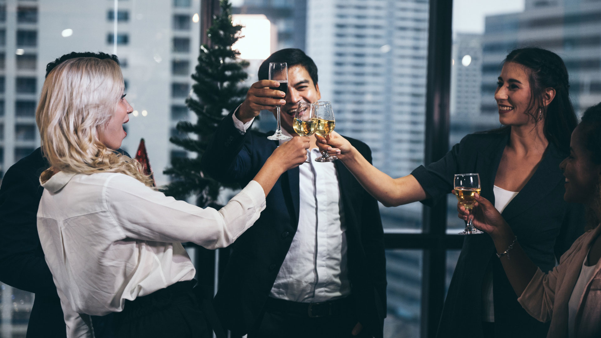 Employees cheering after getting a limousine rental to help celebrate their corporate holiday party