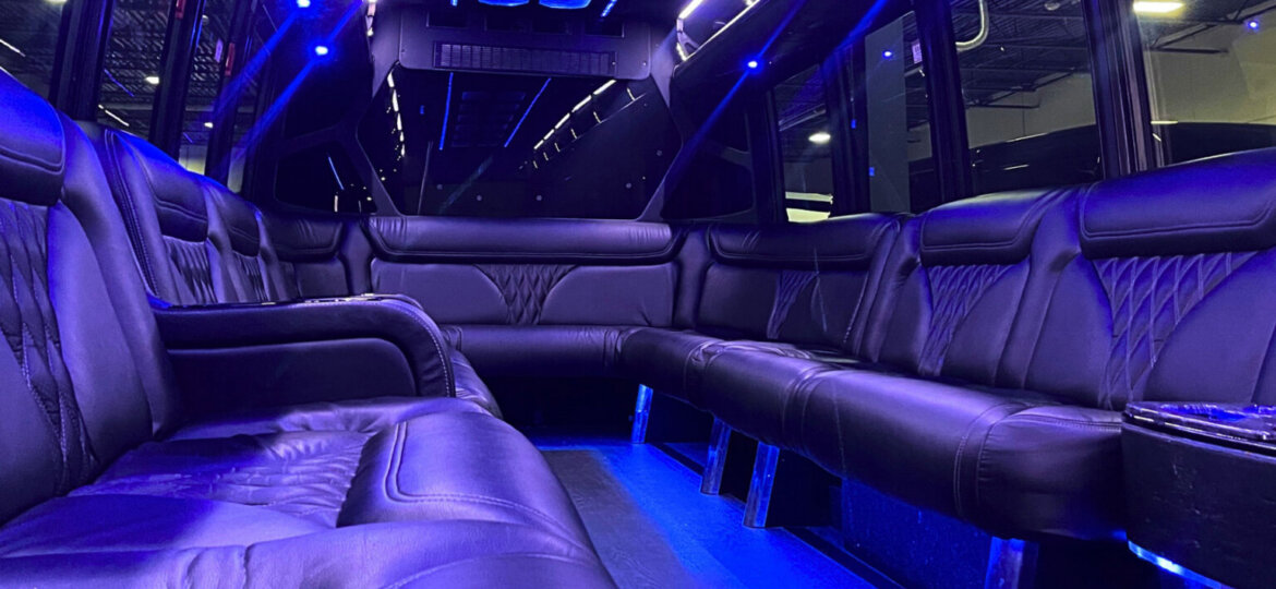 Interior shot of a spacious Detroit party bus featuring comfortable seating and vibrant lighting