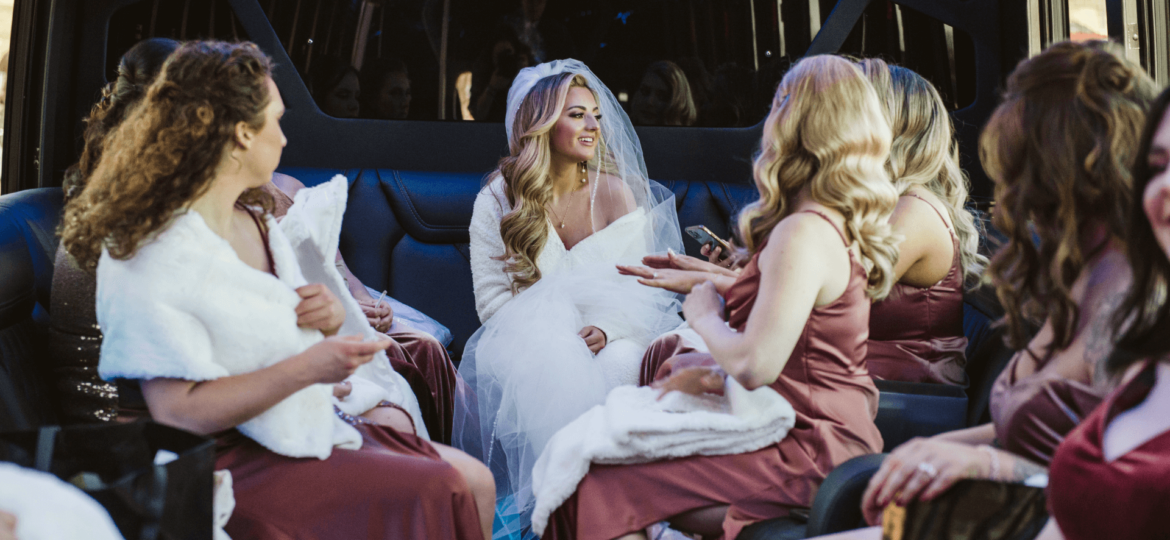 A wedding party talking inside a Dream Limousine stretch sedan during their big day thanks to their wedding transportation planning.