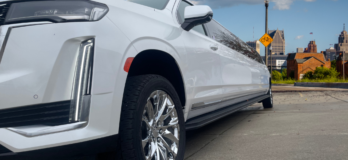 A sleek limousine parked in downtown Detroit, ready for a luxury city tour.