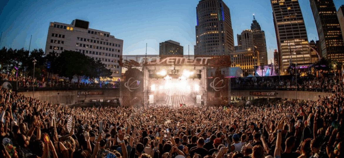 Crowd dancing in front of the Movement Festival stage in Detroit, perfect backdrop for party bus rentals, limo services, and Detroit limousine transportation.