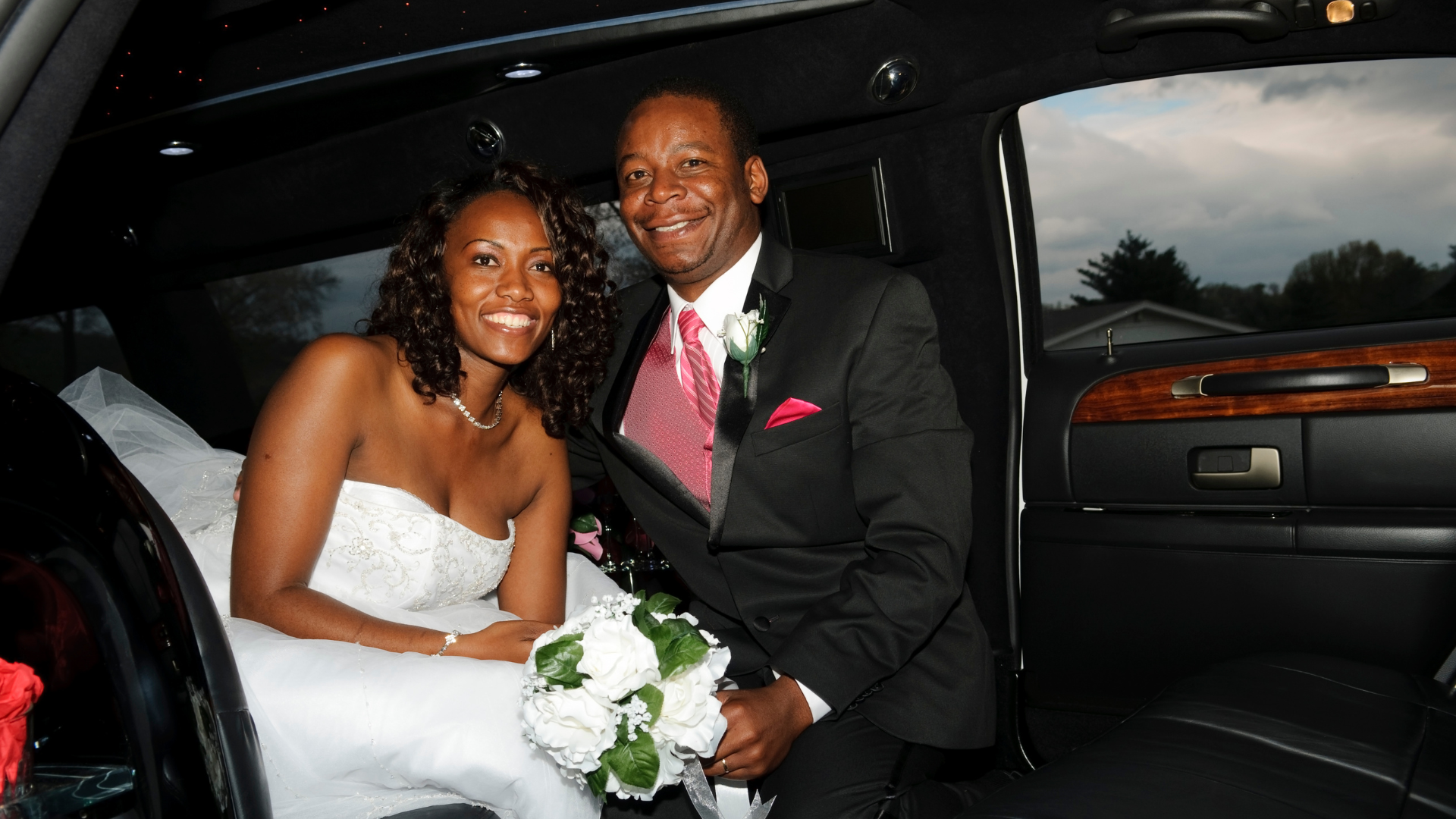 A bride and groom in a limousine rental from Dream Limousine