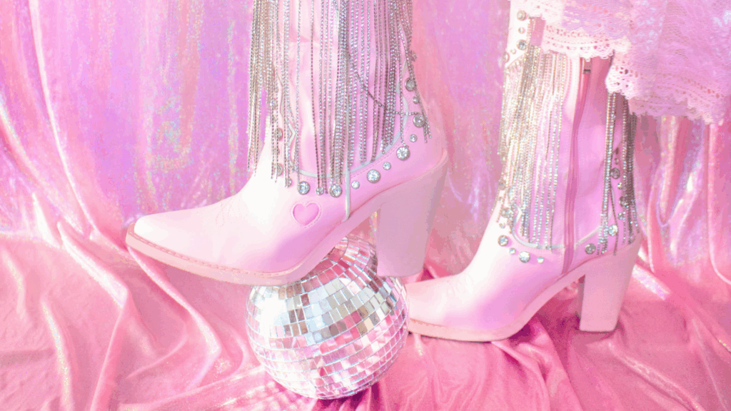 A pink boots with fringes and a disco ball matching a retro disco chic wedding theme, perfectly matching the party bus rental.
